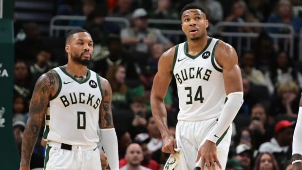 Giannis Antetokounmpo and Damian Lillard on the court.